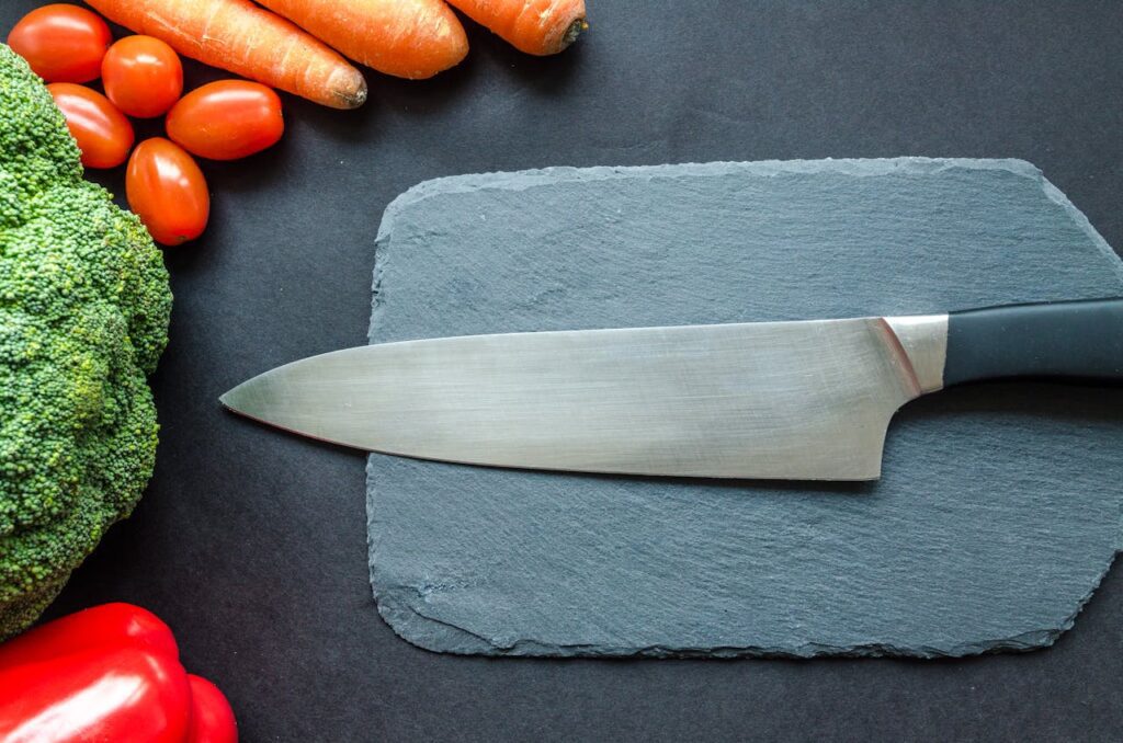Knife surrounded by fresh vegetables